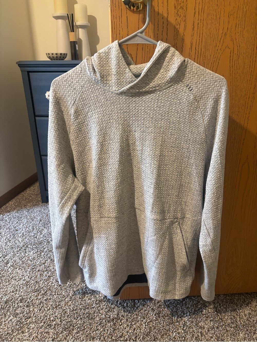 Men’s Lululemon At Ease Hoodie in a heathered light grey color.